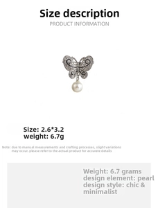 Detailed view of silver butterfly brooch with crystals, pearl drop, and dimensions