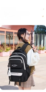 Detail of minimalist black and white backpack with star charm and printed straps