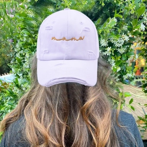 Detail of lavender baseball cap with gold mama embroidery and vintage distressed finish