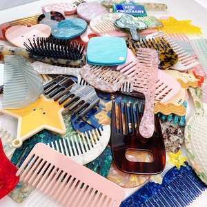 Handmade acetate hair combs in various colors and styles with marble and tortoiseshell patterns