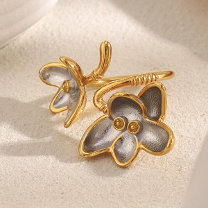 Macro close-up of dual-tone flower open ring in vintage gold and matte silver