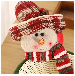 Detail of Christmas snowman woven bamboo basket with red plaid hat and pine cone accents