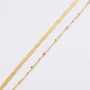 Detail of layered gold snake chain and beaded satellite chain in stainless steel