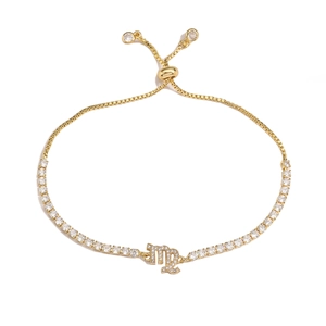 Detail of gold Virgo zodiac bracelet with sparkling rhinestones and adjustable pull chain