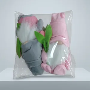 Pink and grey tulip gnome plush dolls inside transparent protective plastic packaging