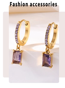 Macro detail of 18K gold plated drop earrings featuring square purple zircon stones