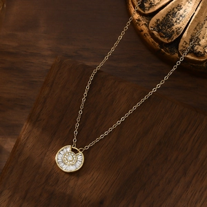 Close-up of gold plated starburst necklace with micro-pave zircons on a dark wood background