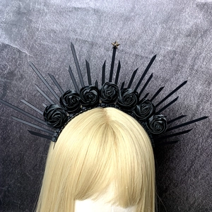 Detail of gothic halo headband with black roses, dark sunburst spikes and a gold star