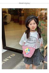 Detail view of a child wearing the pink woven crossbody bag with sunflower decor