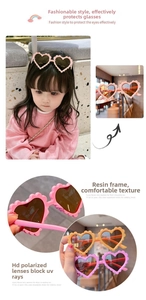 Close-up of heart-shaped kids sunglasses with resin frames and polarized lenses