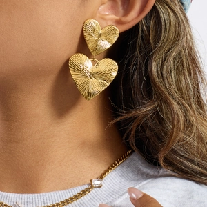 Minimalist 18K gold stainless steel heart drop earrings with ribbed texture on female model