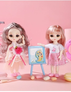 Detail of princess dolls with brown and pink hair including a toy easel and marshmallows