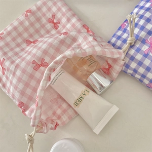 Macro view of pink and blue checkered drawstring storage bags for cosmetics and jewelry