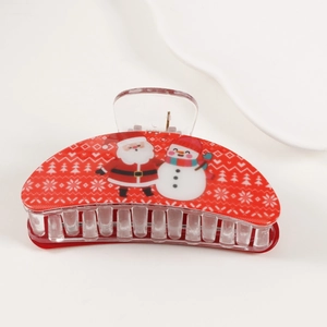 Detail of red Christmas hair claw clip with Santa Claus, snowmen and snowflake patterns