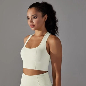 Close-up of seamless ribbed fabric on a cream yellow racerback sports bra and leggings set