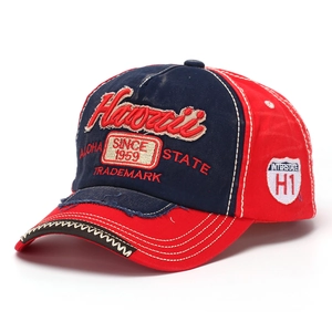 Detail of vintage washed denim baseball cap with Hawaii embroidery and distressed edges