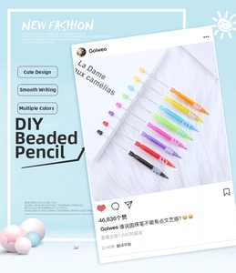 Macro detail of eight colorful DIY beaded pencils set on an open French magazine