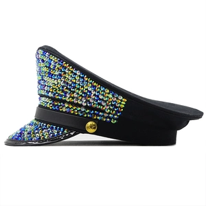 Close-up of black flat top hat featuring colorful rhinestones and gold star buttons