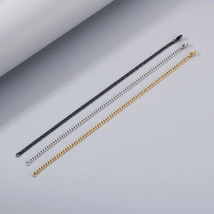 Detailed macro view of minimalist stainless steel thin chains in black, silver, and gold