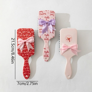 Christmas bow hairbrush set in red, pink, and beige with holiday reindeer prints