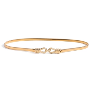 Elastic gold metal waist chain for women with minimalist knot buckle on white background