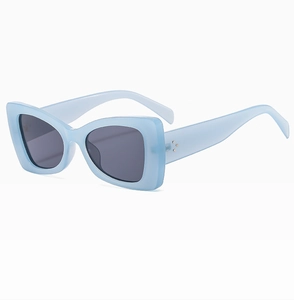Detail of vintage blue rectangle sunglasses featuring triple metal rivet accents on temples