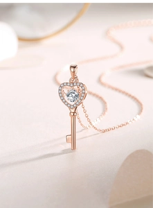 Detailed macro shot of rose gold heart key pendant with sparkling dancing stone