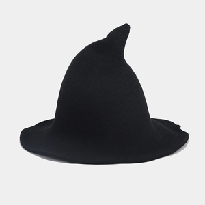 Detailed view of the black knitted witch hat showing fine knit texture and wavy brim