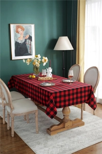 Classic red and black plaid Christmas tablecloth styled in a cozy dining room setting