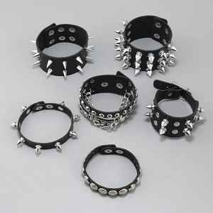 Detail of 6-piece black leather punk bracelets set with silver metal spikes and studs