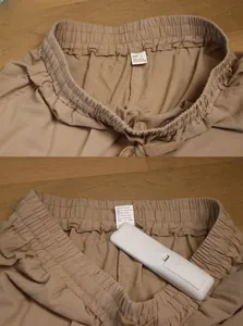 Detail of khaki linen pants featuring elastic waistband and drawstring for men