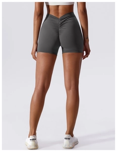 Detail of high-waisted grey yoga shorts featuring V-shaped waistband and scrunch butt design