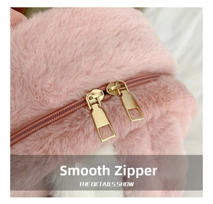 Detail of pink lamb fleece bag featuring premium gold dual metal zippers and smooth plush texture