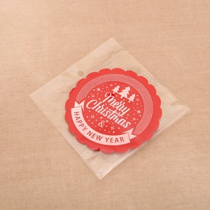 Close-up of red Christmas felt coasters with Merry Christmas print and festive wavy edges