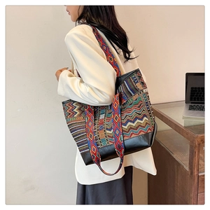Ethnic style canvas tote bag with geometric wave patterns and black leather bottom