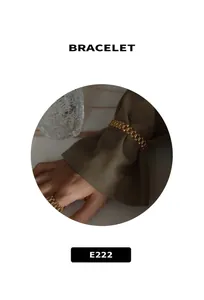 Detail view of the gold watch-link style bracelet and ring set for women