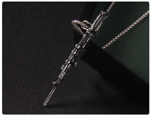 Macro view of a retro stainless steel sniper rifle pendant with detailed matte finish