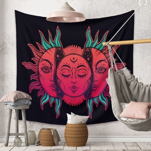 Detail of bohemian sun and moon tapestry on a white wall with minimalist room decor