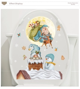 Detail view of Santa Claus and snowman Christmas stickers applied on a white toilet lid