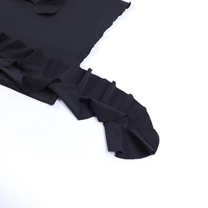 Detail shot of the ruffled black knitted fabric edges and pleated texture on this mini skirt