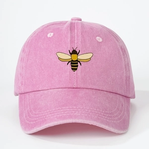 Detailed embroidery of a small bee on a pink washed cotton baseball cap texture