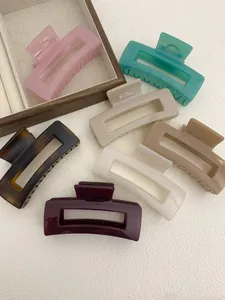 Detailed view of seven large rectangular claw clips in assorted glossy fashion colors