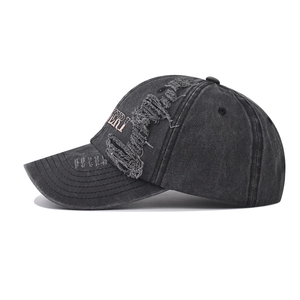 Close-up of vintage washed gray cotton baseball cap featuring torn edges and ERI embroidery