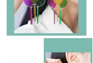 Macro detail of colorful glitter balloon earrings with purple and green acrylic pendants