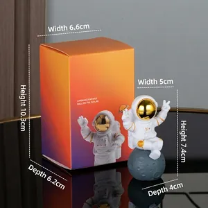 Astronaut figure sitting on moon with victory sign and orange gradient gift box