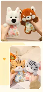 Close-up of soft plush animal dolls featuring floral outfits in hand for scale