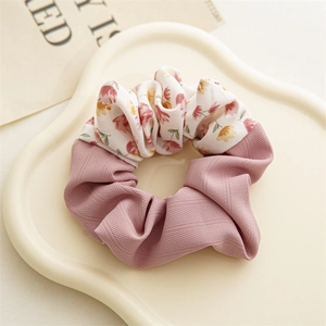 Close-up of floral print and dusty pink herringbone fabric patchwork scrunchie