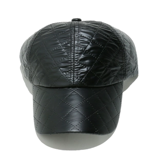 Detail shot of black baseball cap with quilted diamond pattern and padded texture