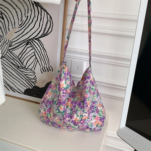 Detail of floral canvas tote bag showing purple and green patterns on high-quality fabric