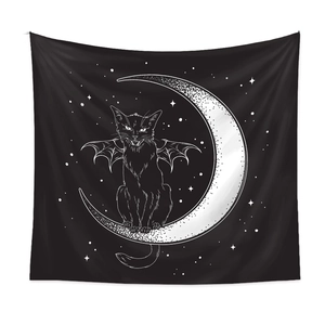 Detail of wall tapestry featuring black cat with bat wings sitting on a crescent moon